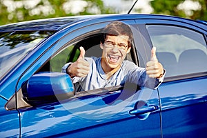 Guy inside car showing thumbs up