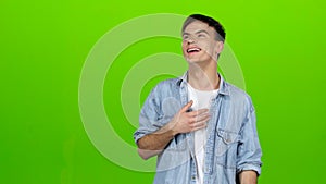 Guy jokes, he is not bored, he is happy and positive. Green screen