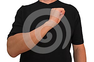 Guy keeps arm on breast near heart with fist. Gesture of man in black t-shirt isolated with no face. Concept of vigor and