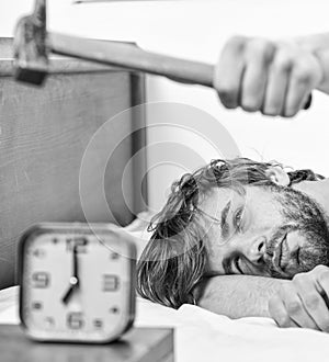 Guy knocking with hammer alarm clock ringing. Break discipline regime. Annoying sound. Man bearded annoyed sleepy face