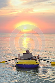 Guy with laptop in the boat