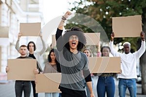 Guy leading international group of students strikers with blank placards photo