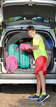 Guy loads bags in the baggage car