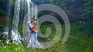 Guy long haired girl make selfie against foamy waterfall