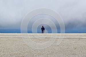 Guy in low clouds near the Transalpina serpentines road DN67C. This is one of the most beautiful alpine routes in Romania