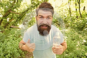 guy maintains body water balance. hydration. daily water. cheerful bearded man hold bottle