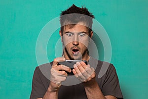 Guy making a selfie with funny faces. Guy taking pictures with his smartphone