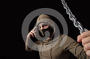 Guy in a mask and hood with chains