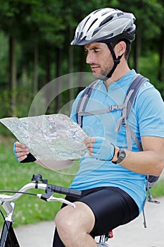 guy on mountain bike looking at map