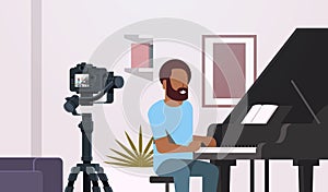 Guy musical blogger recording video on camera african american man playing classical piano music blog concept modern