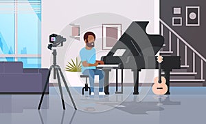 Guy musical blogger recording video on camera african american man playing classical piano music blog concept modern