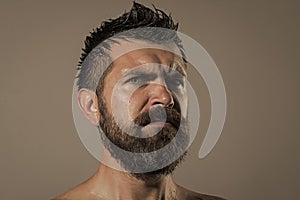 Guy with naked shoulder on grey background.