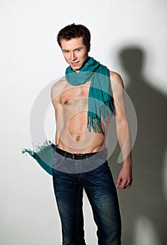 Guy with naked torso and green scarf around neck