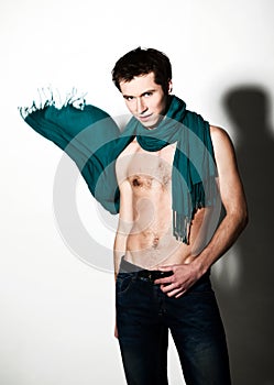 Guy with naked torso and green scarf around neck