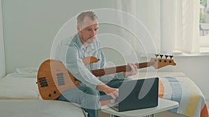 guy playing on guitar enjoy hobby at home