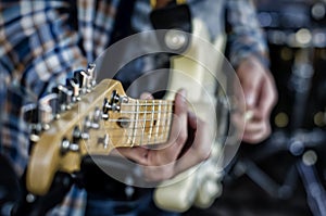 Guy plays the guitar, guitar neck