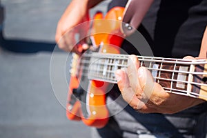 The guy plays an orange bass guitar