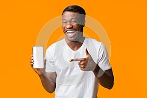 Guy Pointing Finger At Phone Screen Laughing, Orange Background, Mockup