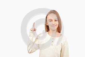 Guy pointing up at empty space. Boy gesturing new idea. Emotional portrait of happy teen boy over white background with copy space