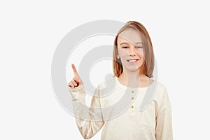 Guy pointing up at empty space. Boy gesturing new idea. Emotional portrait of happy teen boy over white background with copy space