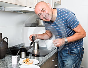 Guy pours coffee into a cup of coffee pot