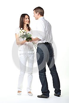 Guy presenting flowers to young lady