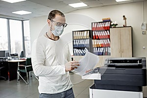 Guy in protective mask  copies documents