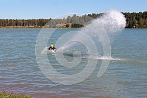 Guy put water spurt from the jet ski. photo