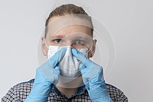 Guy puts on respiratory mask. Attractive man puts on face mask and looks at camera. Cold, flu, virus, tonsillitis, acute