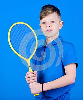 Guy with racket enjoy game. Future champion. Dreaming about sport career. Athlete kid tennis racket on blue background