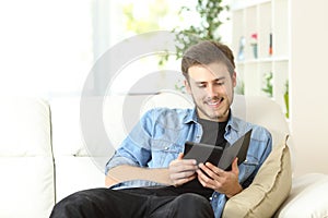 Guy reading a book in an ebook reader