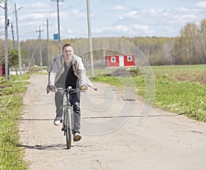 A guy riding a bike on rural roads