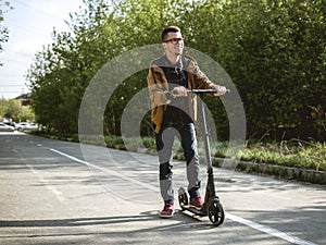 The guy riding on the kickscooter