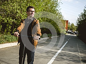 The guy riding on the kickscooter