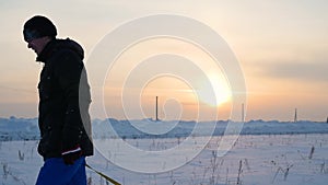 The guy rises to snowy hill with snowtube.slow motion. snow winter landscape. Sunset time