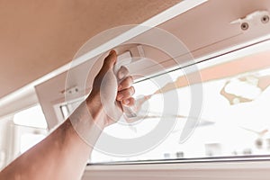 The guy`s hand opens a plastic double window for the handle pvc double glazing