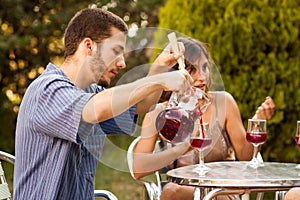Guy serving sangria with friends in a terrace