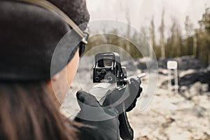 A guy shoots from a hunting rifle on the shooting range in the desert sport shooting