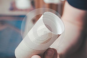 Guy Sitting On The Toilet Holding An Empty Toilet Paper Roll