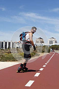 Guy skating in-line backwards