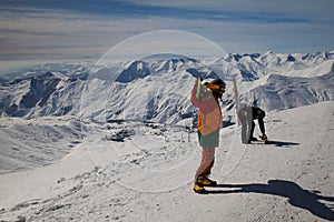 Snowboarder walking with a snowboard in the winter. Ski touring in the snowy mountains on a sunny day