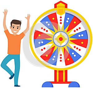 Guy spinning wheel of fortune to win prize. Young man dancing and celebrating victory, jackpot