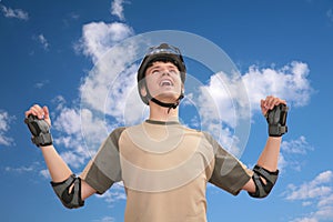 Guy in sports helmet with rised hands