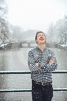 Guy is standing on a bridge