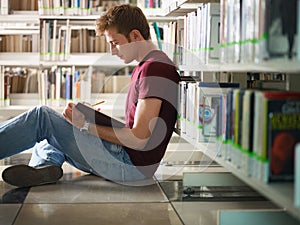 Guy studying in library