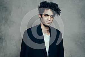 guy in suit curly hair t-shirt gray background model cropped view teenager
