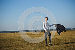 A guy in a suit walks on the field