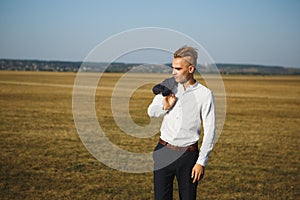 A guy in a suit walks on the field