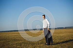 A guy in a suit walks on the field