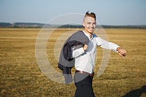 A guy in a suit walks on the field